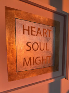 Heart Soul Might artwork on the wall at sunset